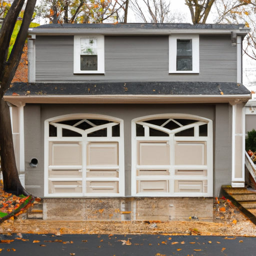 Residential garage door in South Orange, NJ on an overcast autumn day with wet driveway and fallen leaves
